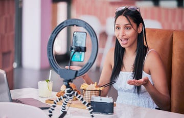 woman influencer, food review blog and content creator filming online video in cafe restaurant creative live streaming, shooting 5g web vlog and virtual mobile phone app broadcast for social media