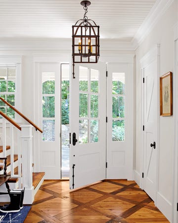 home entrance with wood floors and staircase