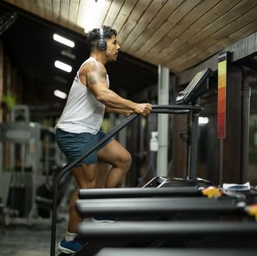 young man at the gym exercising on a the stair machine