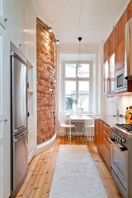 Shotgun Kitchen with Exposed Brick Wall