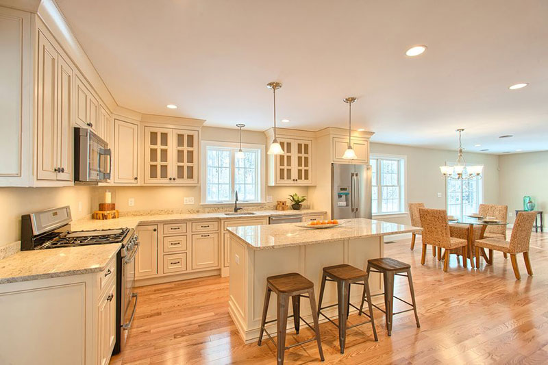 Cream kitchen cabinets with colonial  granite countertops