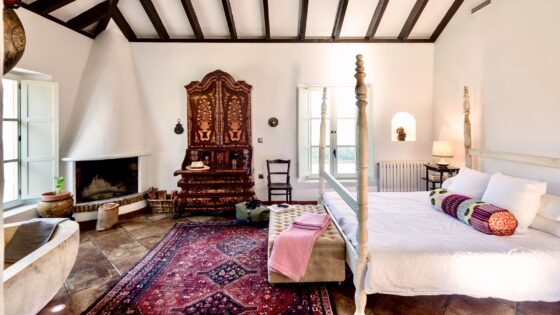 andalucian style interior guestroom with four poster bed and freestanding bath in finca la gloria