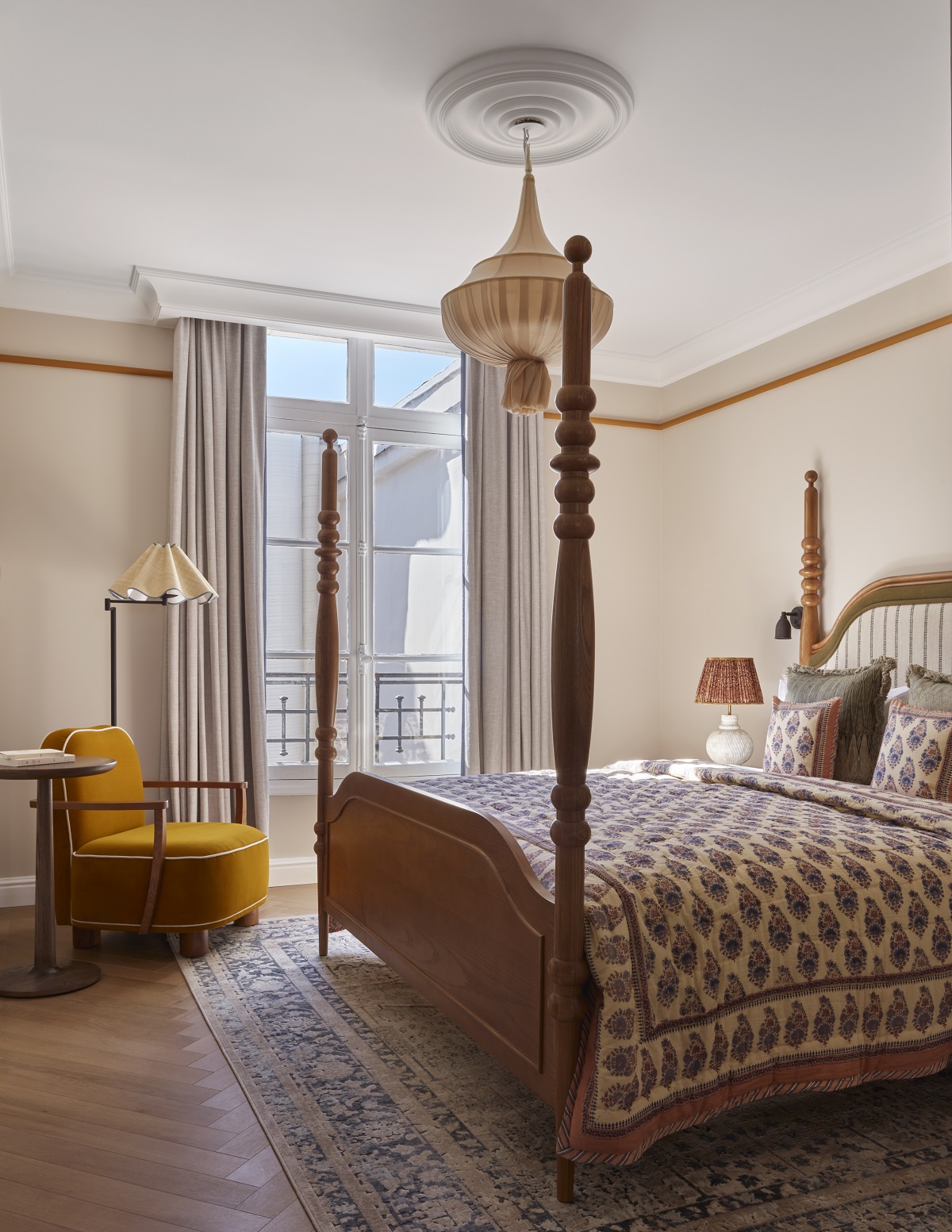 antique bed and vintage accessories in hotel guestroom in Paris