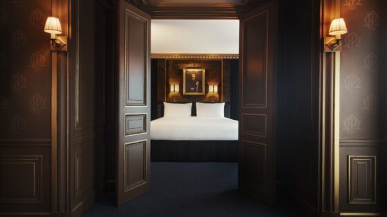 view from corridor into guestroom with portrait on the wall above the bed in Maison Proust