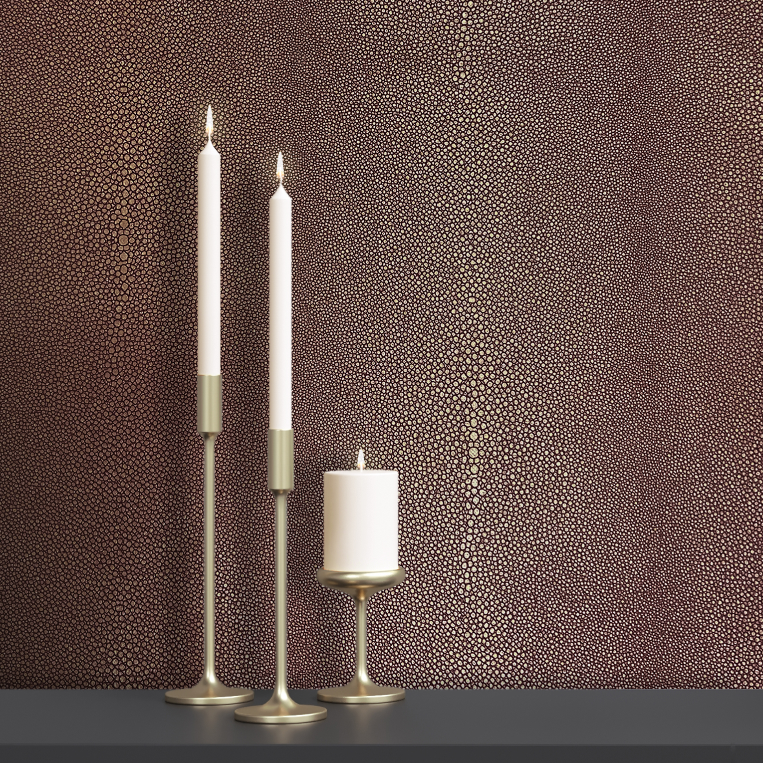 3 brass candlesticks and candles against Newmor Shagreen wallcovering