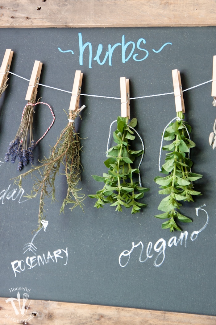 Make drying your herbs a part of your decor with this DIY rustic chalkboard herb drying rack. It's made from an old pallet and makes preserving herbs beautiful. | Housefulofhandmade.com