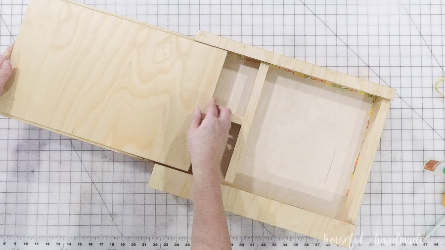 Sliding the cover over the storage compartments of the DIY lap desk.