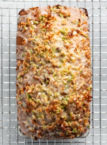 an aerial view of coconut lime banana bread on a wire rack