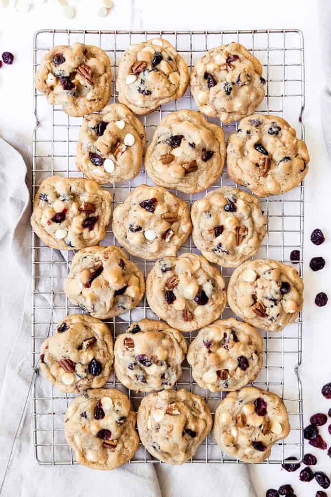 White chocolate cranberry cookies cooling on a wire rack.