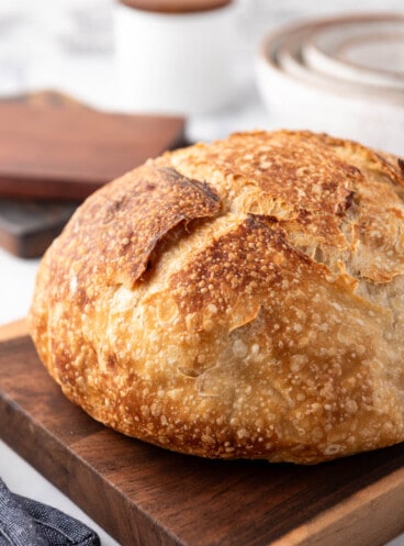 A close image of homemade sourdough bread with a golden brown crust.