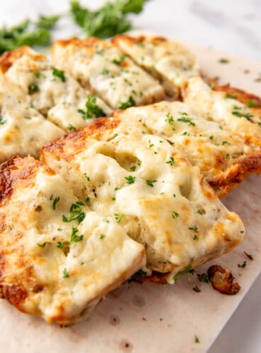 Thick slices of cheesy garlic mozzarella bread.