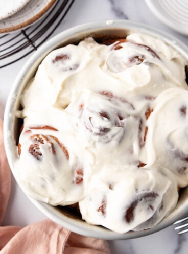 An overhead image of cinnamon rolls frosted with cream cheese icing.