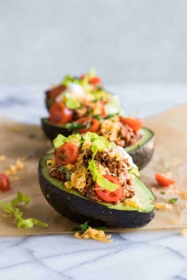 Row of taco stuffed avocado halves.