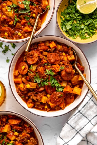 Bowls served with cowboy stew and topped with fresh parsley.