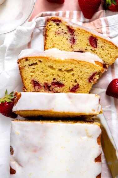 Sliced Strawberry Lemon Loaf Cake topped with a lemon glaze.