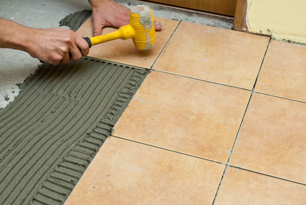 Laying tile on tile adhesive