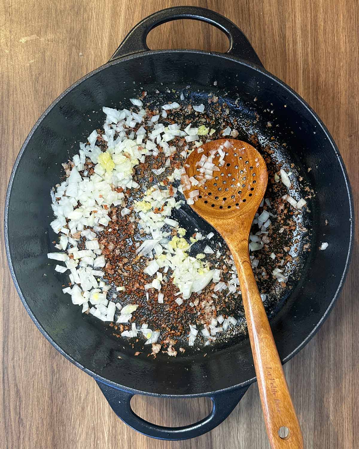 Diced onions and crushed garlic in the pan.