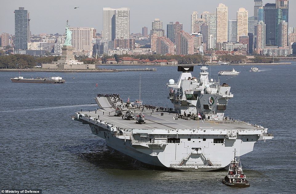 Welcome to New York! The United Kingdom's largest and most powerful warship, HMS Queen Elizabeth, is pictured arriving in New York City under the gaze of Lady Liberty yesterday on her maiden deployment