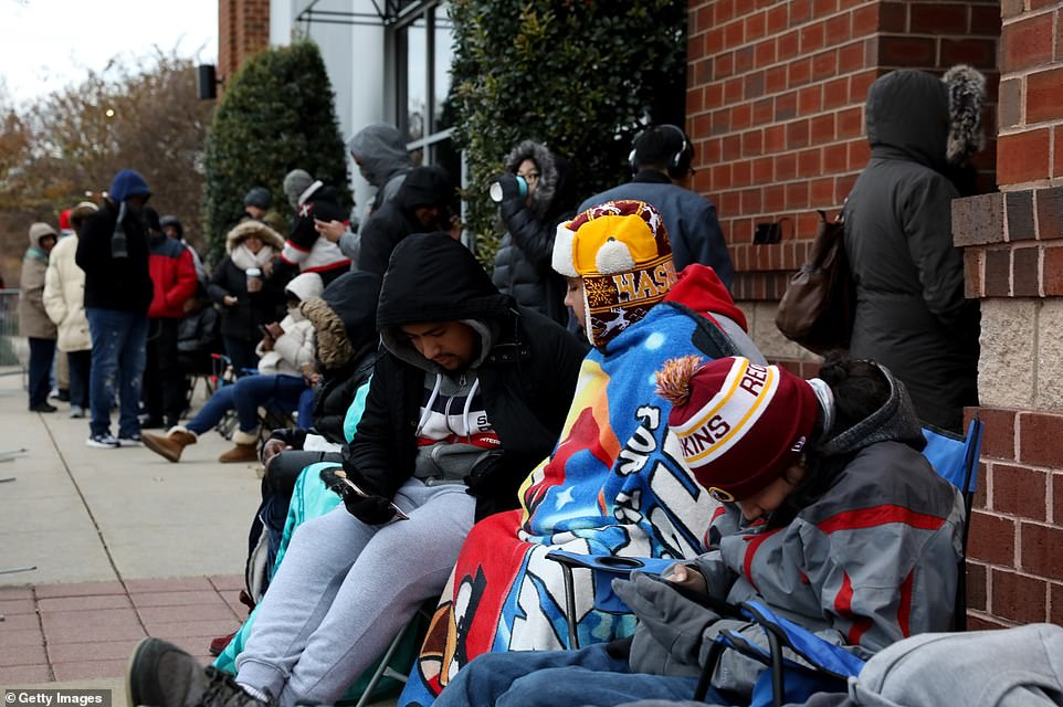 Shoppers could be seen entertaining themselves on their phones or guzzling down coffee as they waited in line together 