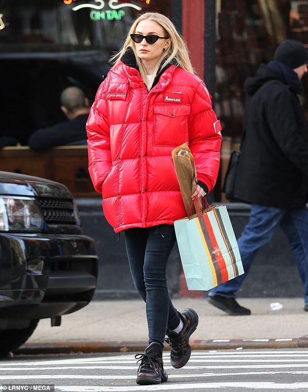 Sophie Turner cuts a casual figure in VERY puffy red coat as she shops ...