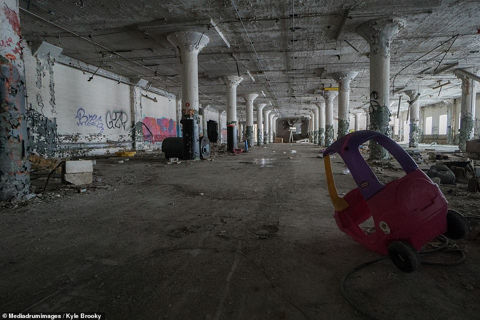 A tipped over children's toy car in the foreground of a destroyed building is a poignant reminder of the significant role the  decline in the US's automobile industry played in the city's downfall 