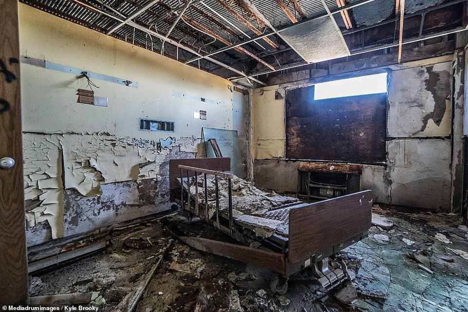 The boom and bust history of Detroit can be defined in numbers. It was the fourth largest city in the U.S. with 1.85 million residents during the height of its success in the 1950s. Today there are fewer than 700,000. Pictured: A decaying hospital bed in the derelict North Greater Detroit Hospital, which is currently one of the estimated 70,000 abandoned buildings in Detroit.