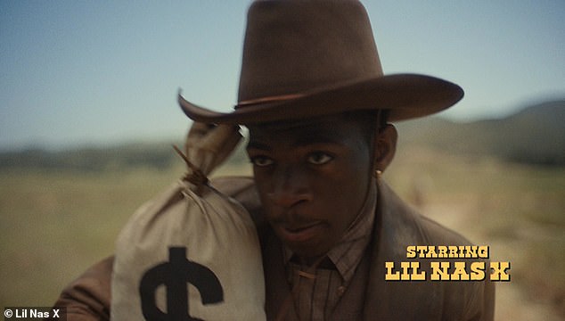 Robbery underway: The cinematic music video opens in circa 1889 with three including Chris Rock and Haha Davis chasing down the rapper and country artist on horseback through an open plain