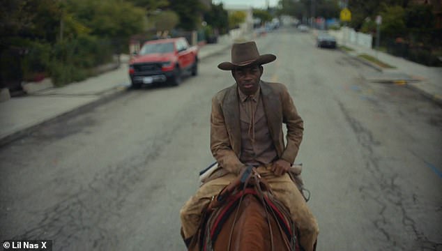 Don't see that everyday: Still on top of his horse, Lil Nas rode through the neighborhood