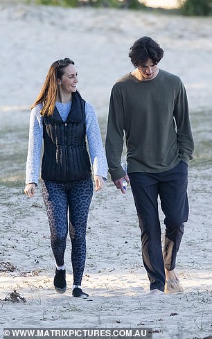 Moving on: Emma, 32, held hands with her male companion as they enjoyed a romantic stroll