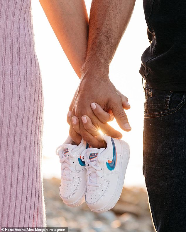 So sweet! The couple is having a little girl and included a tiny pair of Nikes in their shoot