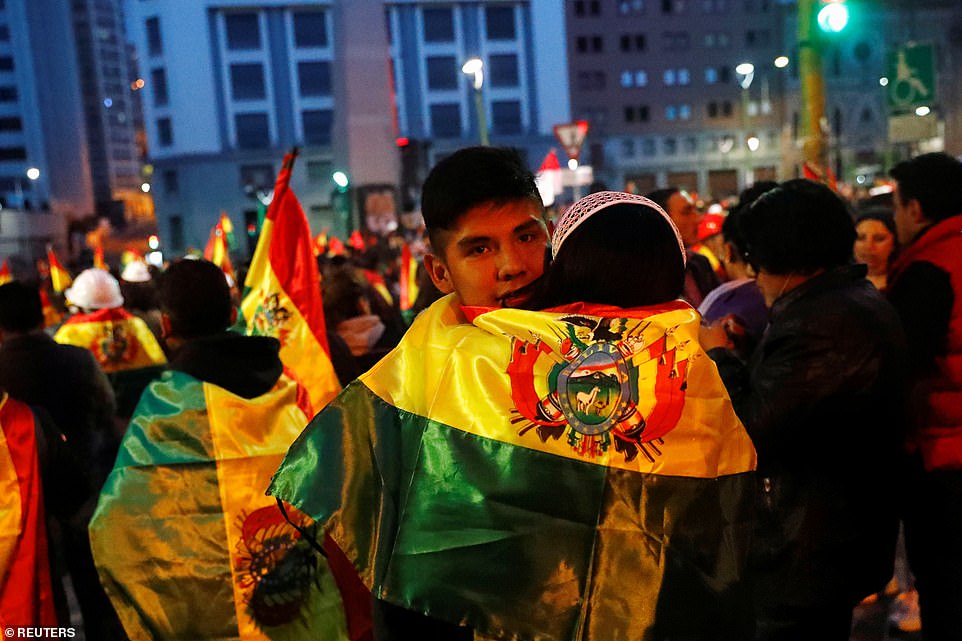 Demonstrators hug during a protest against Bolivia's President Evo Morales in Bolivia on November 9