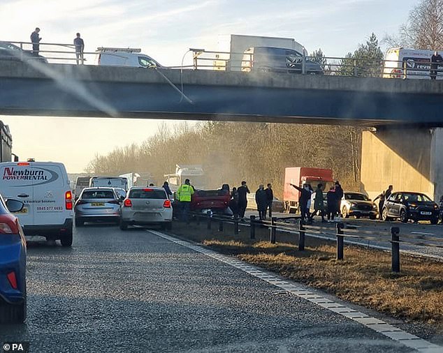 A woman is in critical condition in hospital after a car fell from a bridge and landed in the middle of Bowburn interchange on the A1(M)