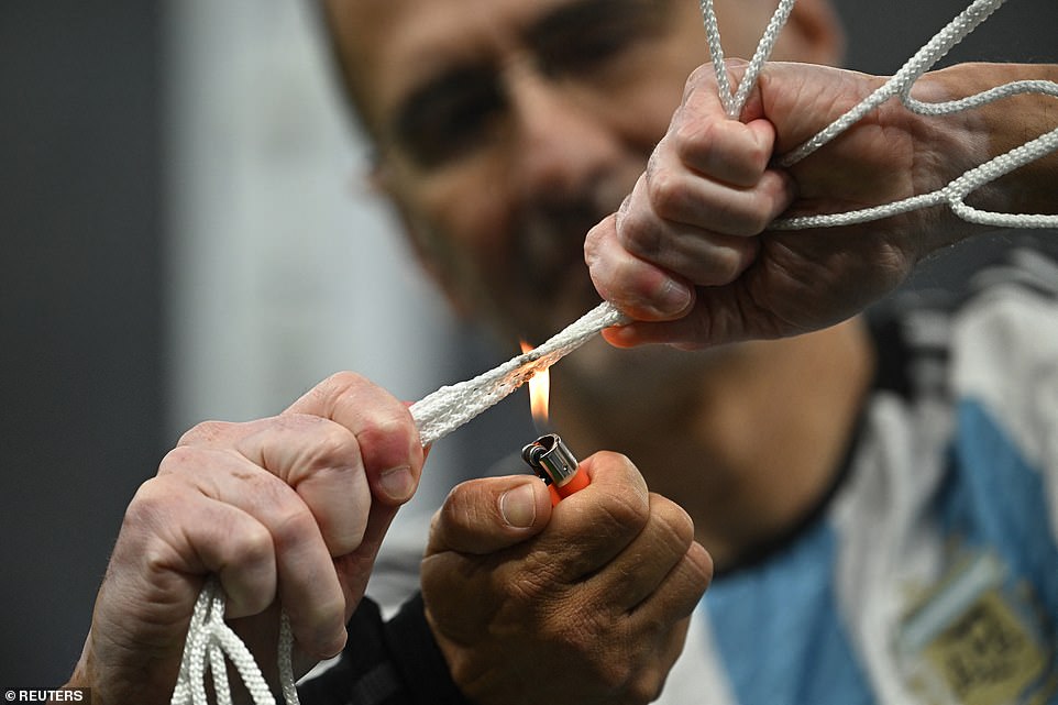 General view as the net from the goal is lit on fire by a lighter after Argentina won the World Cup