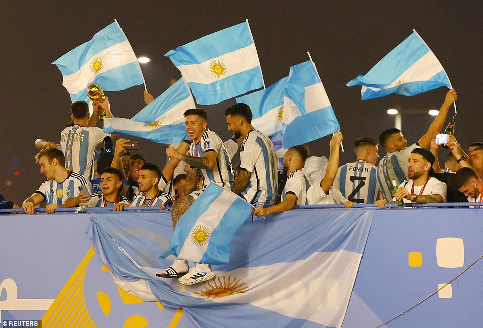 The players made sure to drape their tour bus with the team's national flag and gave the crowd a glimpse of the golden World Cup trophy