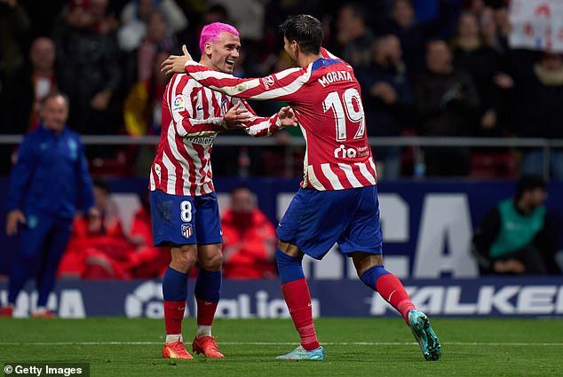 Griezmann, who has previously dyed his hair green before, celebrates with goalscorer Alvaro Morata