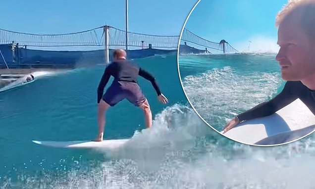 Moment Prince Harry launches into the waves to show off impressive surfing skills at