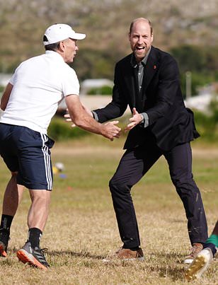 Prince William shows off his rugby skills and is tackled by Springbok legend Joel Stranksy