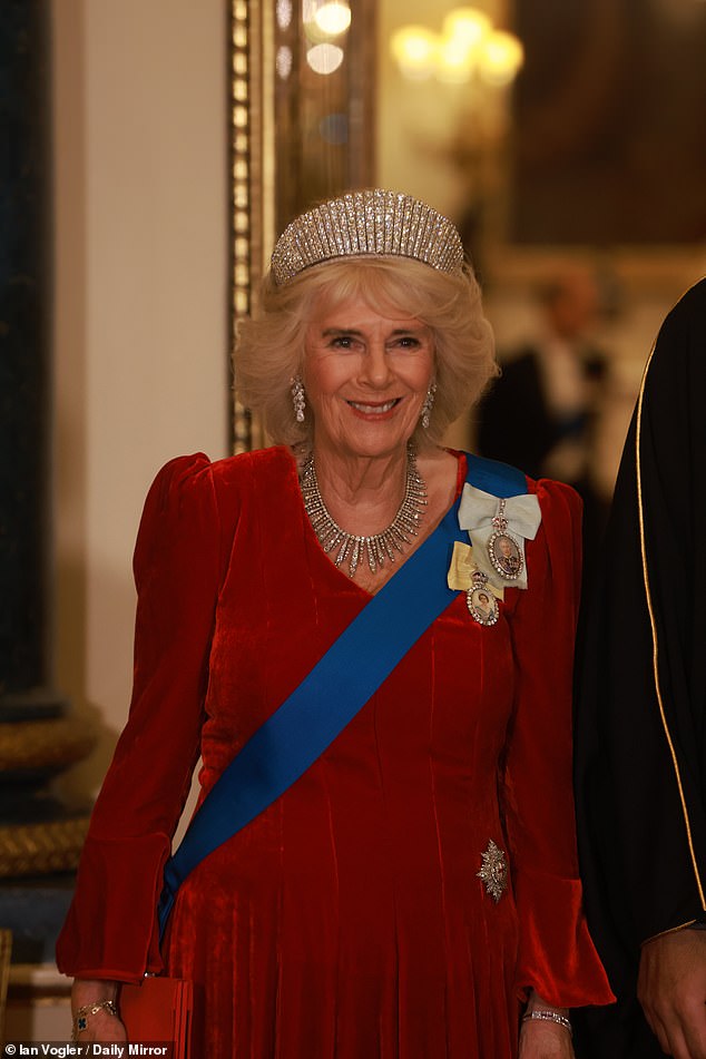 Camilla, 77, paid tribute to the Queen Elizabeth II as she paired her red velvet evening dress by Fiona Clare with, unusually, the diamond kokoshnik tiara belonging to the late monarch