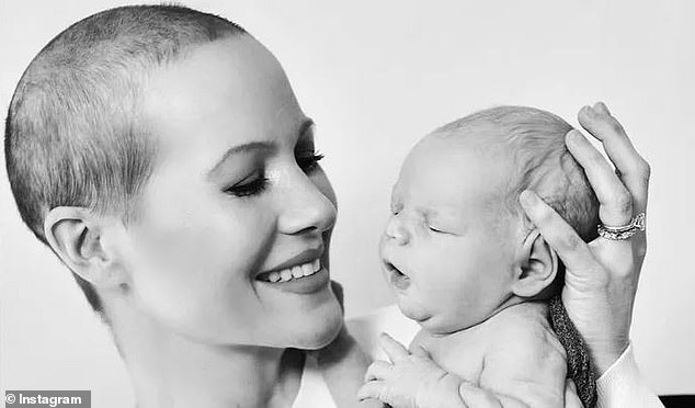 Powers with her baby boy Bennett - who was delivered via surrogate - after she was diagnosed