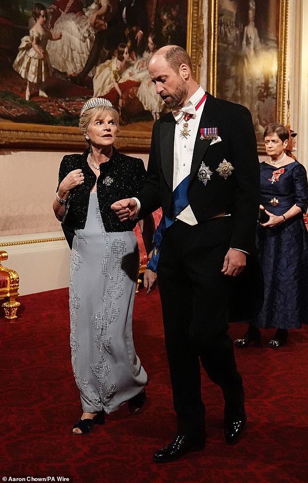 The Viscountess Hood accompanied the Prince of Wales as they made their way along the East Gallery to attend the state banquet for the Emir of Qatar Sheikh Tamim bin Hamad Al Thani at Buckingham Palace