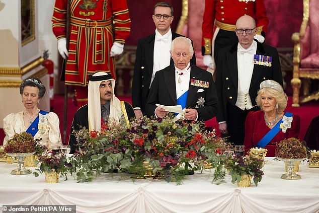 King Charles, seated with Queen Camilla (right), the Emir of Qatar (centre left) and the Princess Royal (left)