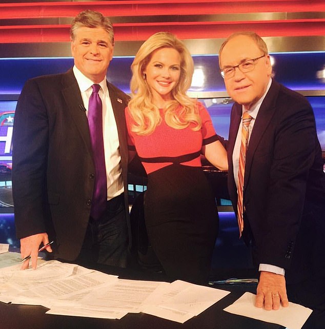 Powers poses on set with Fox News heavyweight Sean Hannity (left)