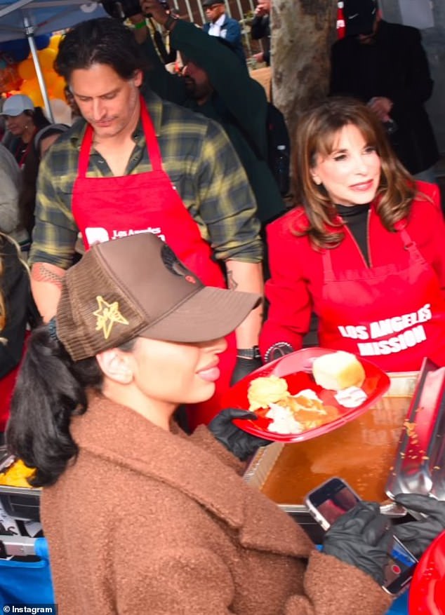 Linder pictured standing next to Joe Manganiello as they helped give out meals