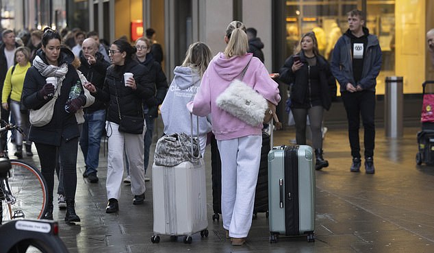 The grieving girlfriend stacked soft bags on top of huge suitcases as she left the London apartment block