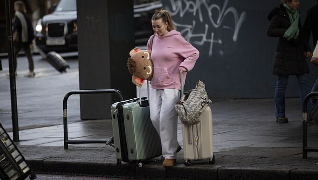 The grieving girlfriend could be seen hauling huge suitcases across the busy London streets