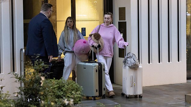 In an emotional scene, the women appeared to thank a man waiting outside the building as they passed him loaded up with bags