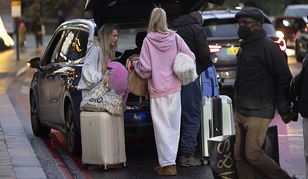 A man then helped them load their baggage into the boot, while they stood by with her remaining possessions