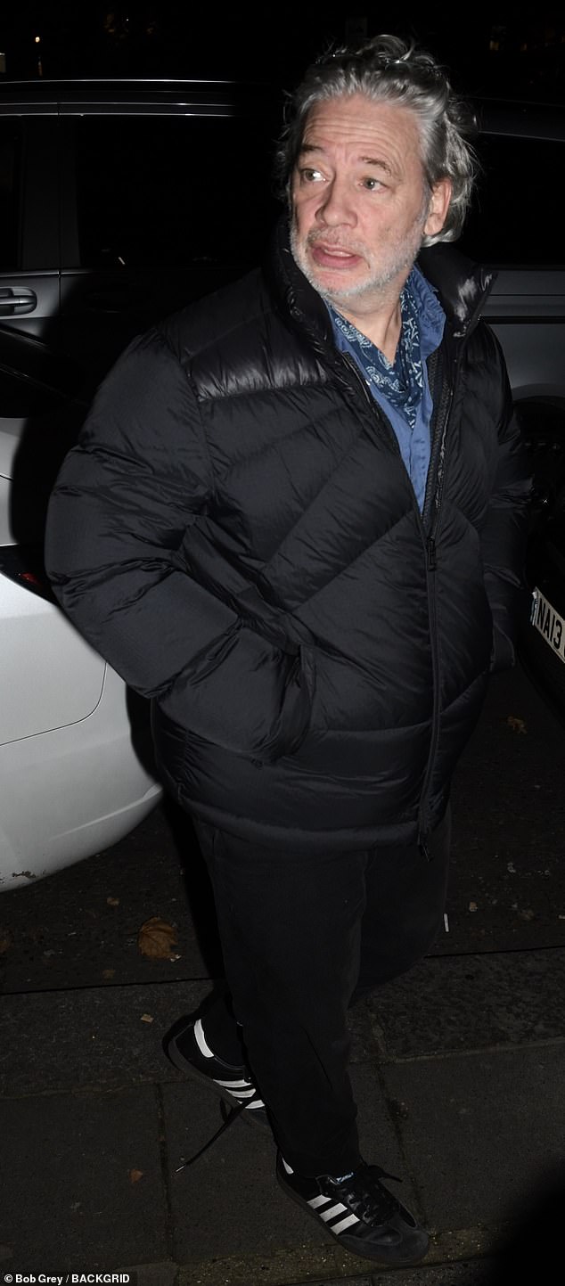 Dexter Fletcher layered a padded coat over a blue shirt for the event