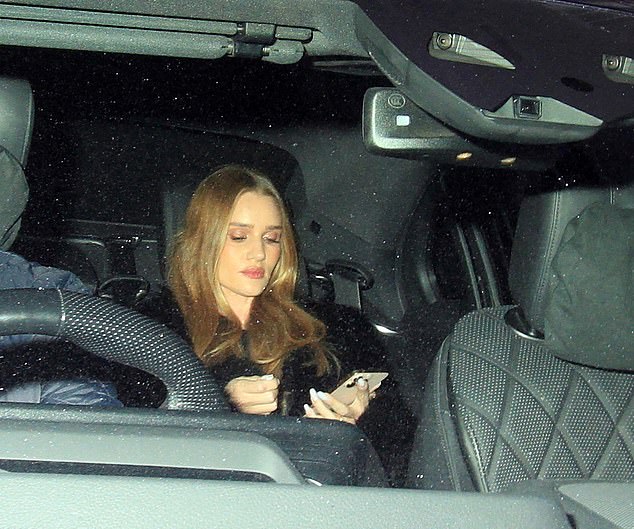 Rosie was glued to her phone as she was taxied home