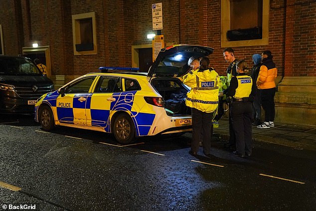 A police car idles on the curb close to O2 City Hall, where Zayn was due to perform